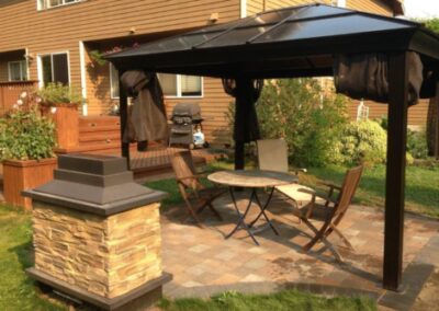Gazebo with table and chairs on patio.